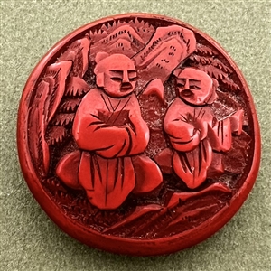 Chinese cinnabar button of an Asian man and boy.