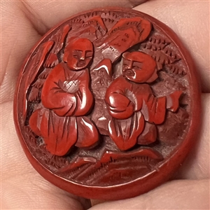 Chinese cinnabar button of an Asian man and boy.