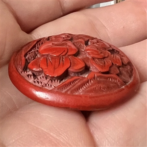 Chinese cinnabar button of an Asian man and boy.