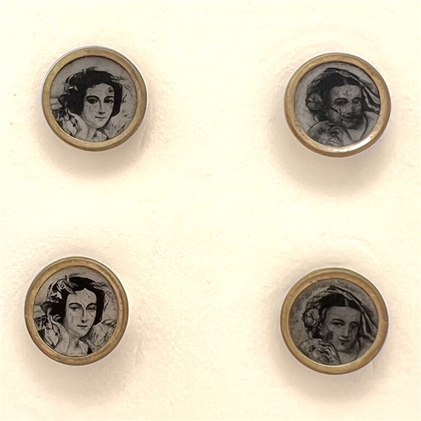 Four tiny tintype buttons of women.