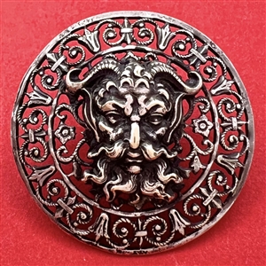 White metal with openwork button of a mythological devil.