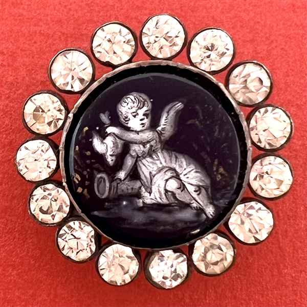 “En grisaille” 19th c. enamel button of cherub holding a dove upside down.