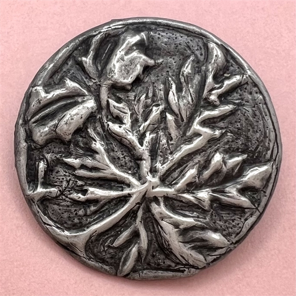 Arts and crafts Repoussé metal button of plant life.