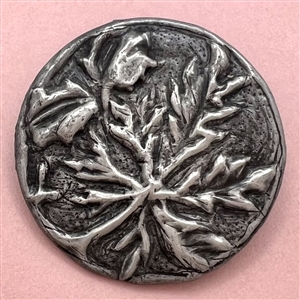 Arts and crafts Repoussé metal button of plant life.