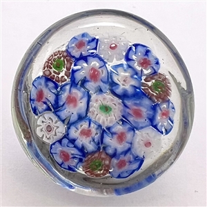 Glass paperweight studio button of flowers.