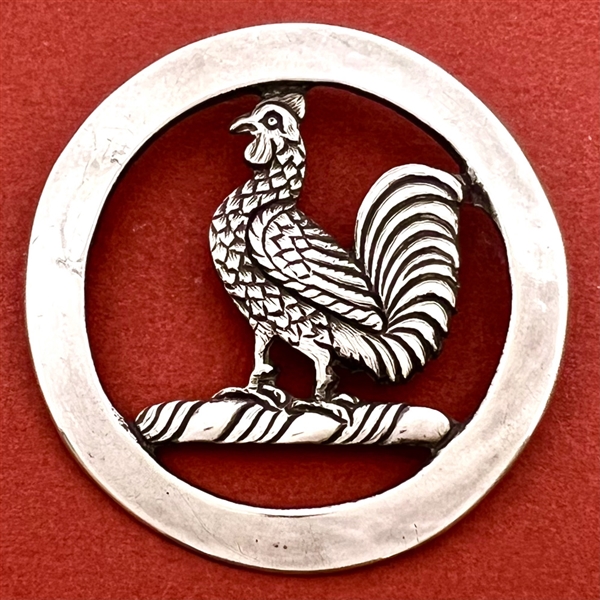 White metal Livery trim of a rooster.