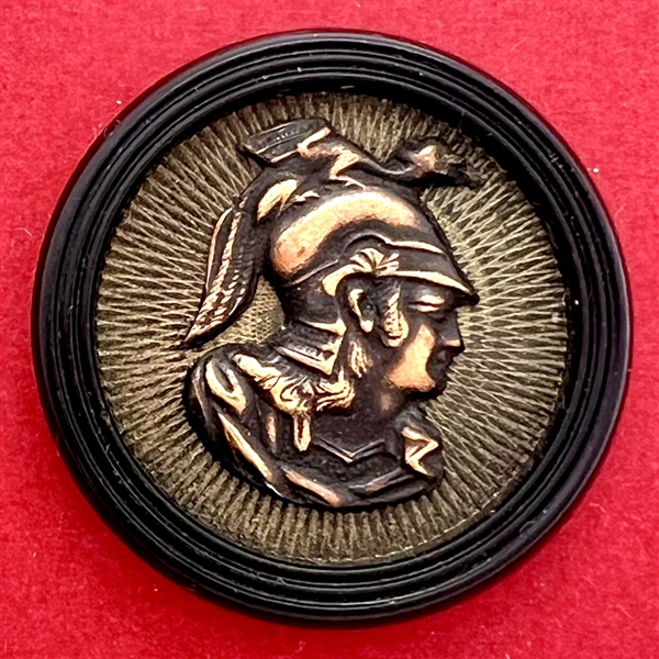 Brass button of Minerva over composition (?).