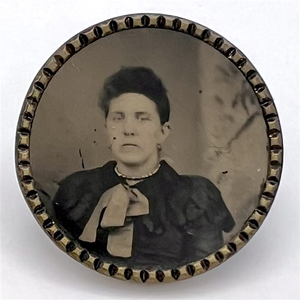 Tintype button of a woman with scarf.