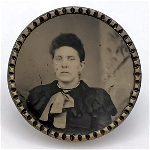 Tintype button of a woman with scarf.