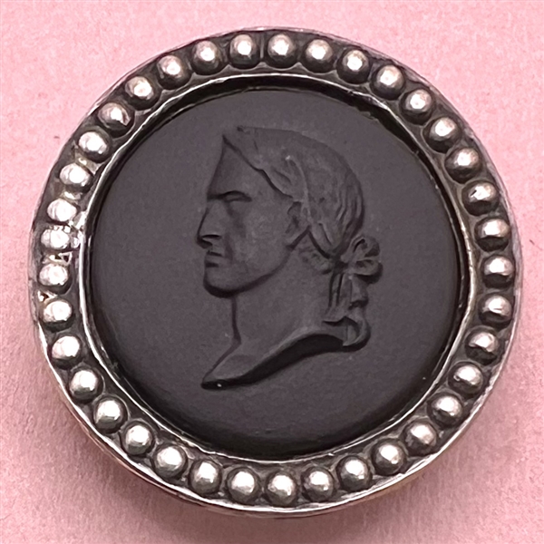 Black Wedgwood button of a man in profile set in silver.