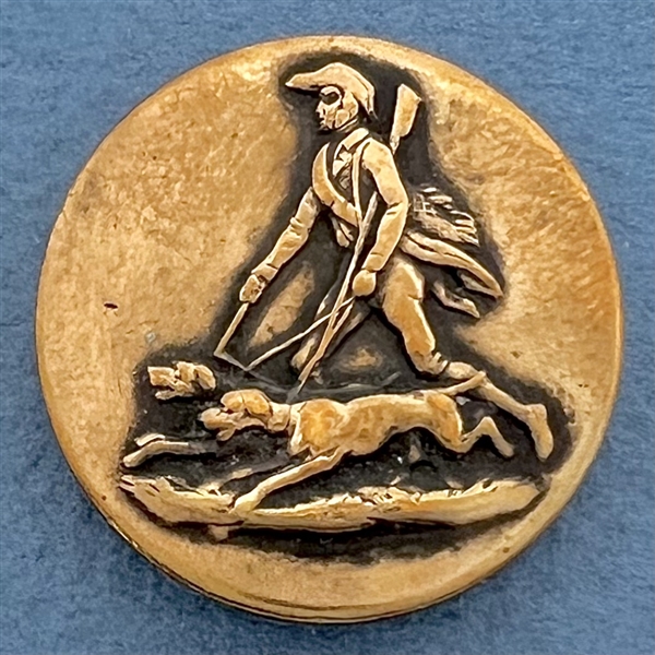 Brass sporting button of a hunter and hounds.