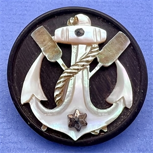 A 19th c. Iridescent pearl anchor, oars and rope over wood button.