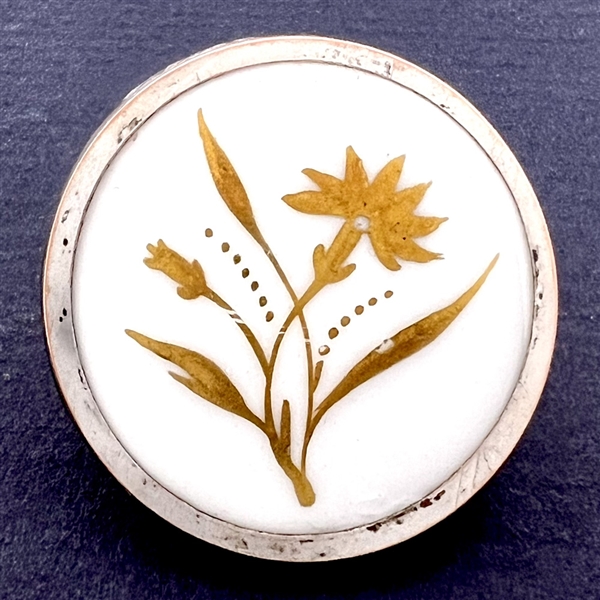 A 19th c. Gold luster painted carnation on white ceramic button.