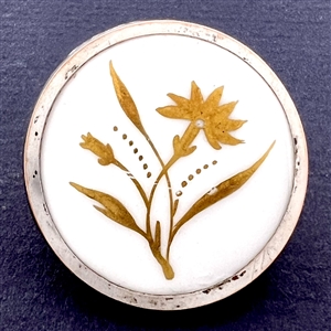 A 19th c. Gold luster painted carnation on white ceramic button.