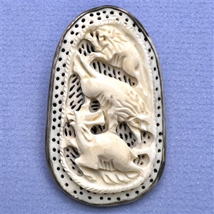 Carved natural material button of lions attacking a deer (?).