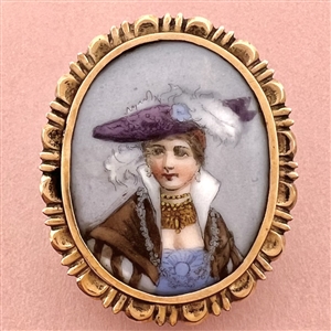 Painted porcelain button of a woman in feathered hat and shawl.