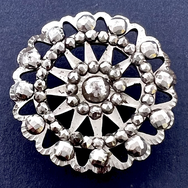 An 18th c. Pierced steel button with polished faceted steels.