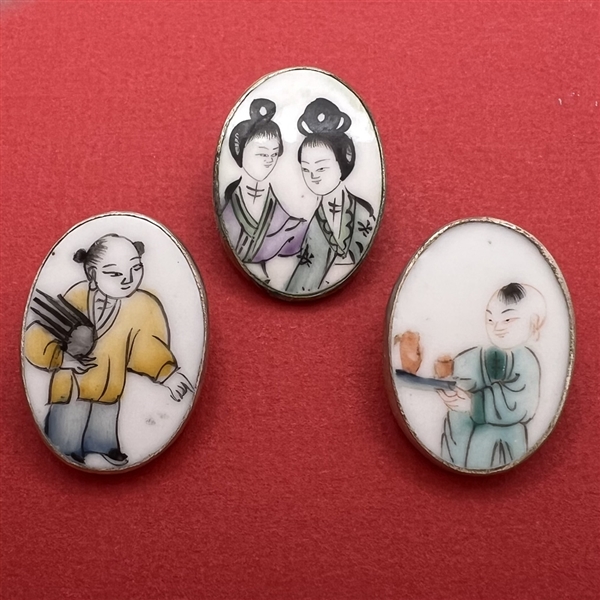 Three shard ceramic buttons of Asian children.