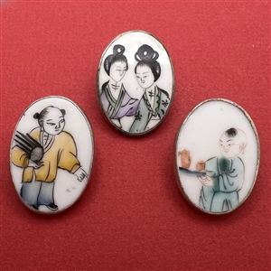 Three shard ceramic buttons of Asian children.