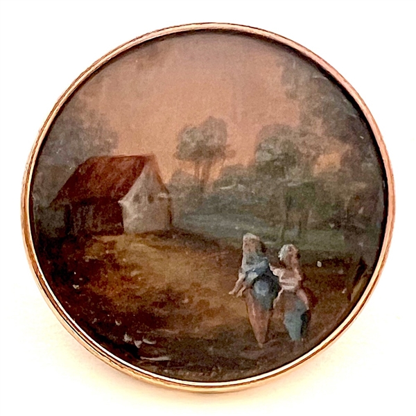 An 18th c. Painting under glass button of a couple in a pastoral scene.