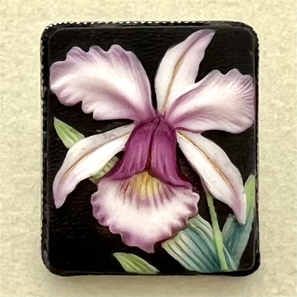 Japanese Arita porcelain button of an orchid set in sterling silver.