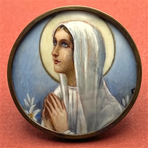 Painting under glass button of woman praying.