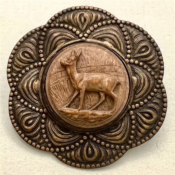 Carved wood deer set in metal button. 