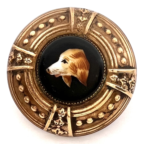 Ceramic button of a dog set in brass.