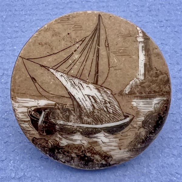 Porcelain button of a sailing ship near shore.