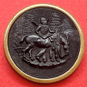 Rimmed horn sporting button of a hunter standing near horse.