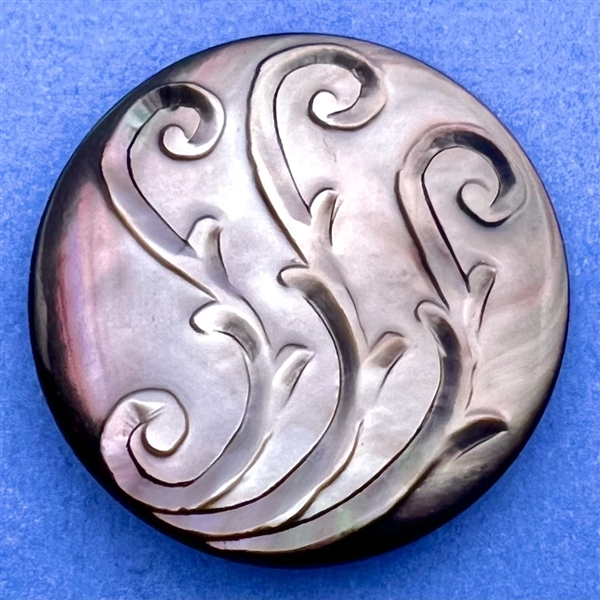 Carved grey pearl button with design of three S’s.