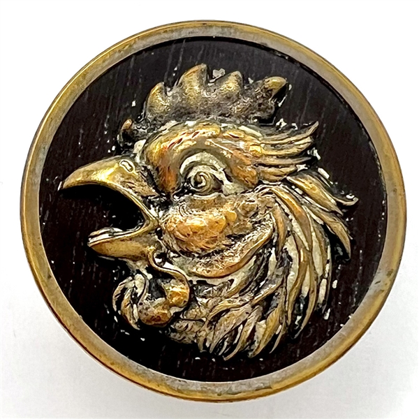 French brass button of a rooster with imitation wood background.