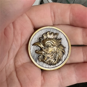 French brass button of a rooster with imitation wood background.