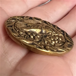 Brass button of a “Dove of peace with velvet background.