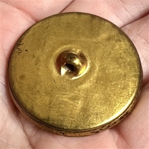 Brass button of a “Dove of peace with velvet background.