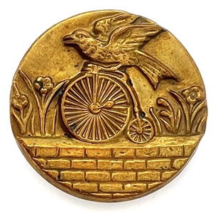 Rare brass button of a parrot riding a penny farthing bicycle.