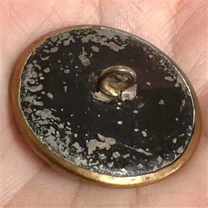 Rare brass button of a parrot riding a penny farthing bicycle.