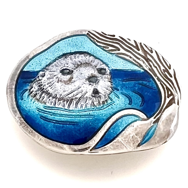 Studio enamel and silver button of an otter.