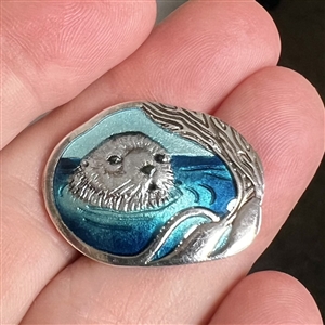 Studio enamel and silver button of an otter.