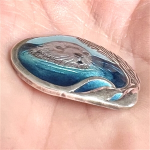 Studio enamel and silver button of an otter.