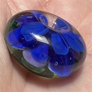 Mary Gaumond's whistle hole glass studio button of a violet.