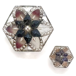 Two hexagonal lacy glass buttons in mother daughter sizes.