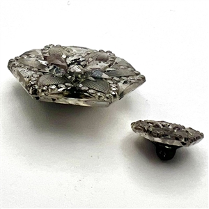 Two hexagonal lacy glass buttons in mother daughter sizes.