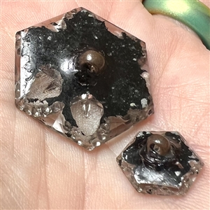 Two hexagonal lacy glass buttons in mother daughter sizes.