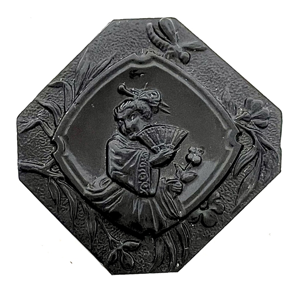 Modified square black glass button of Madame Chrysanthemum. 