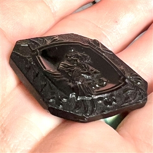 Modified square black glass button of Madame Chrysanthemum. 