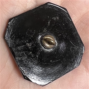 Modified square black glass button of Madame Chrysanthemum. 
