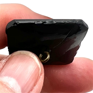 Modified square black glass verbal button of the word “Union with the N's reversed.