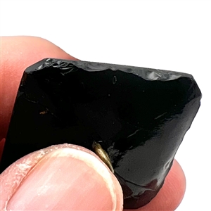 Modified square black glass verbal button of the word “Union with the N's reversed.