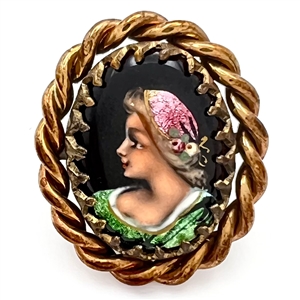 Oval enamel button with foil of a womans profile.